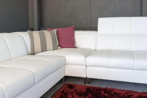 couch with white upholstery and pillows